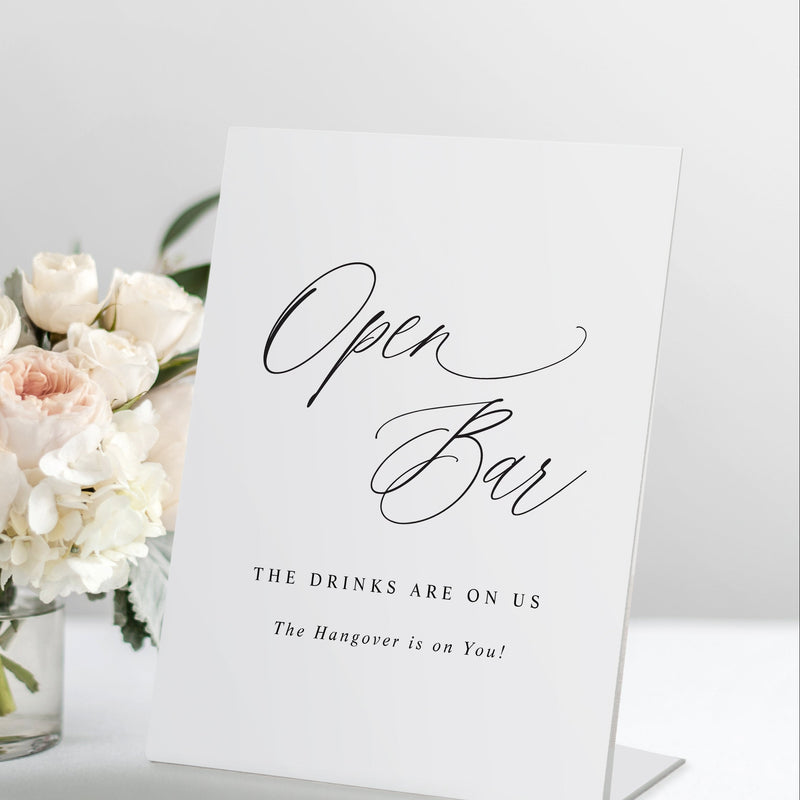 Self-standing open bar wedding sign with soft romantic modern calligraphy on a pedestal display, styled with floral arrangement.