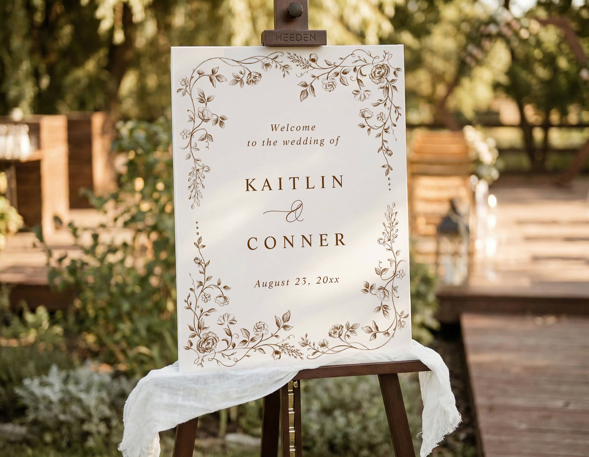 Brown vintage French floral wedding welcome sign on easel