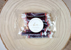 his and her personalized wedding favor stickers applied to wrapped candy favors