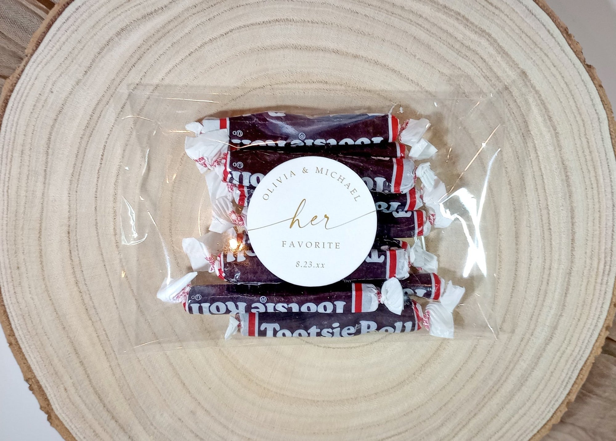 his and her personalized wedding favor stickers applied to wrapped candy favors