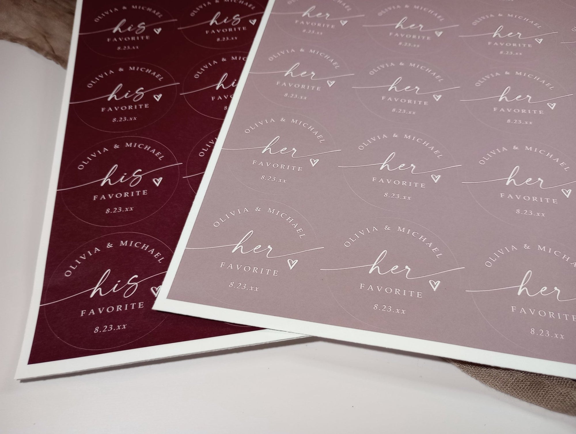 Two sheets of personalized stickers with 'his favorite' and 'her favorite' text on a white surface.