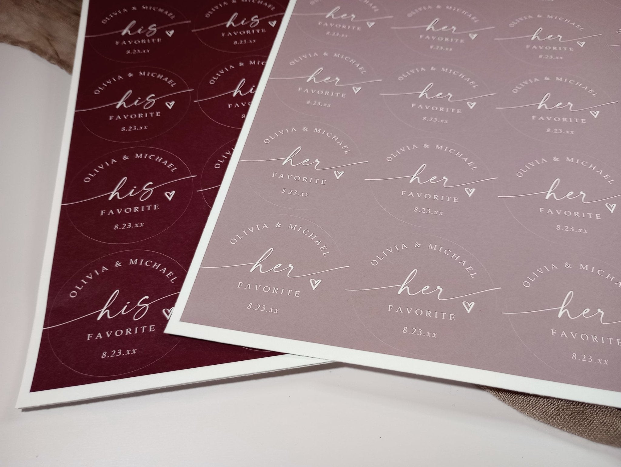 Two sheets of personalized stickers with 'his favorite' and 'her favorite' text on a white surface.