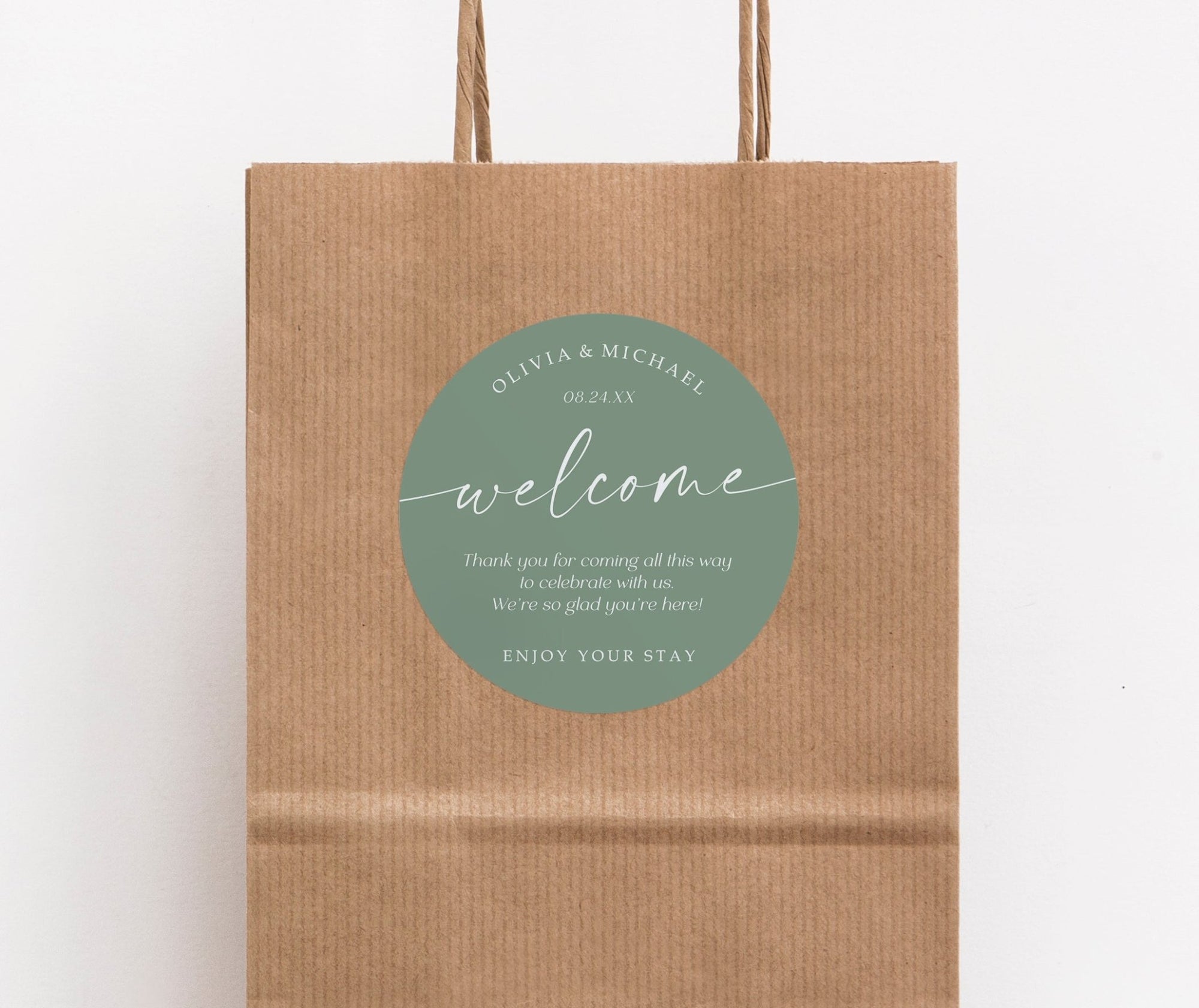 Brown paper bag with a sage green 'welcome' label on a white background