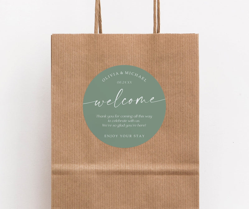 Brown paper bag with a sage green 'welcome' label on a white background