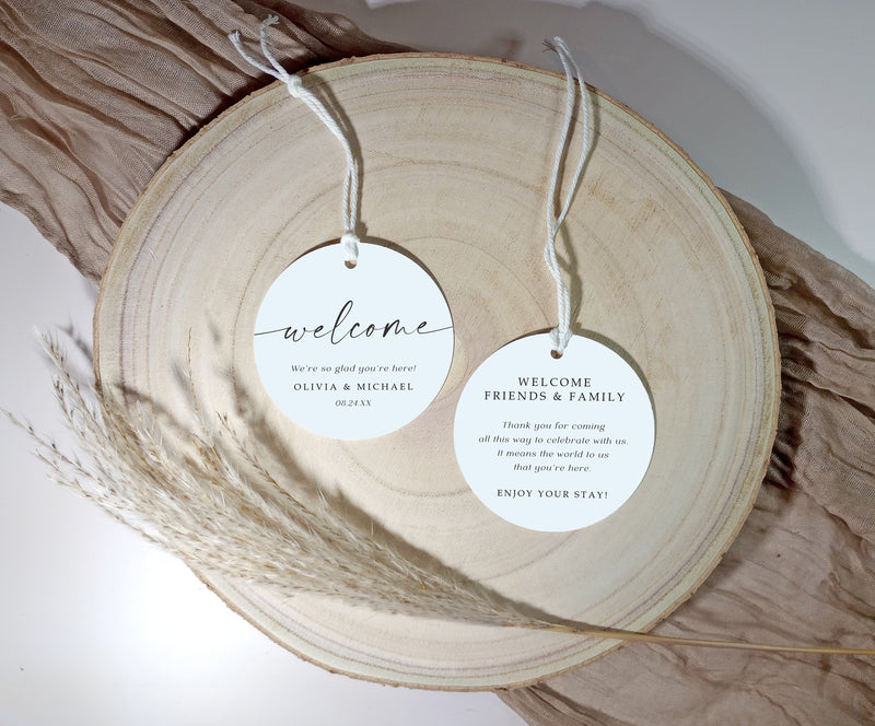 Personalized hotel welcome tags for wedding guest bags on wooden tray