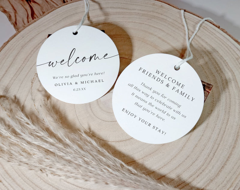 Round welcome tags on a wooden surface