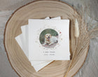 Stack of wedding napkins with a dog photo and text on a wooden surface