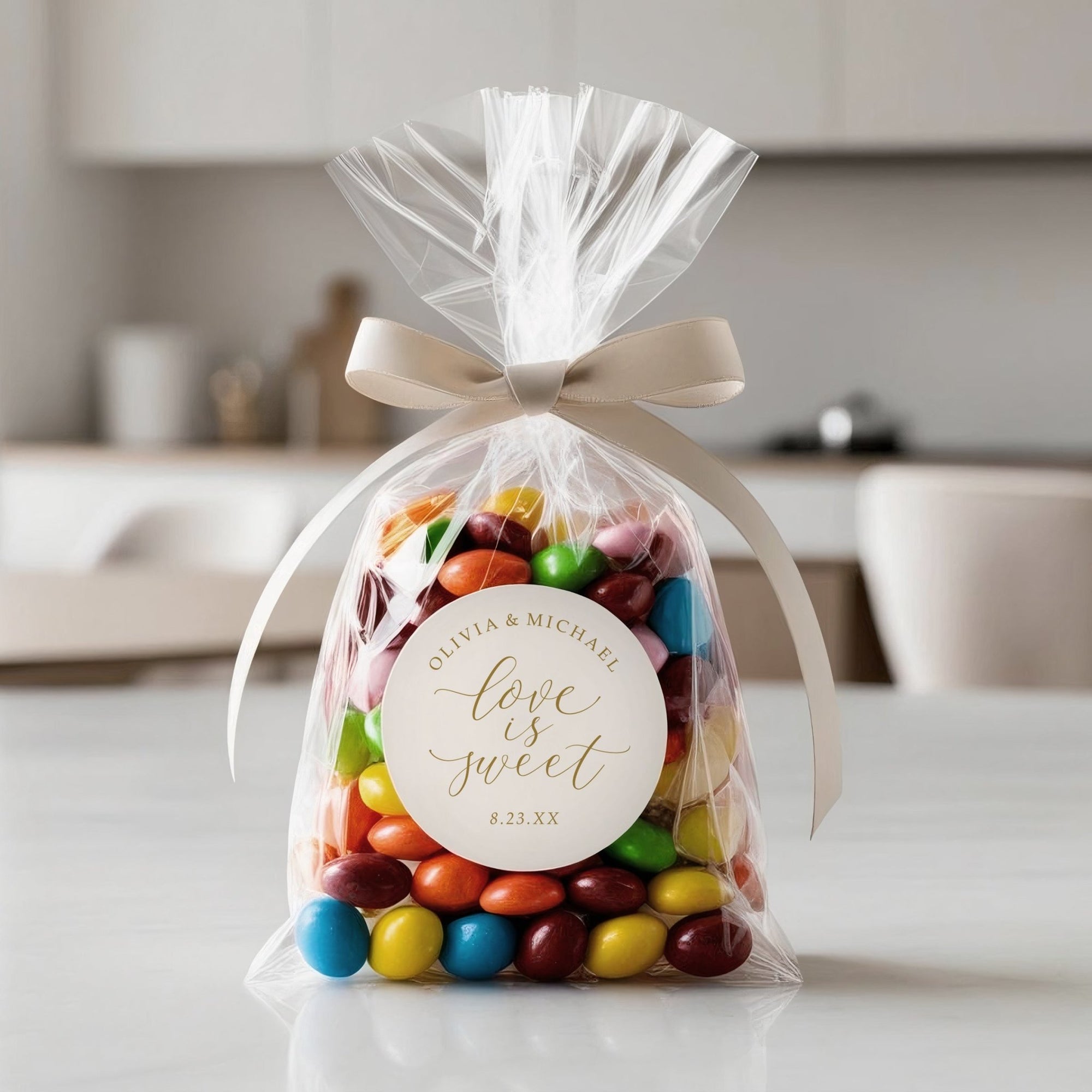 Love is sweet wedding favor sticker on clear bag filled with colorful candy