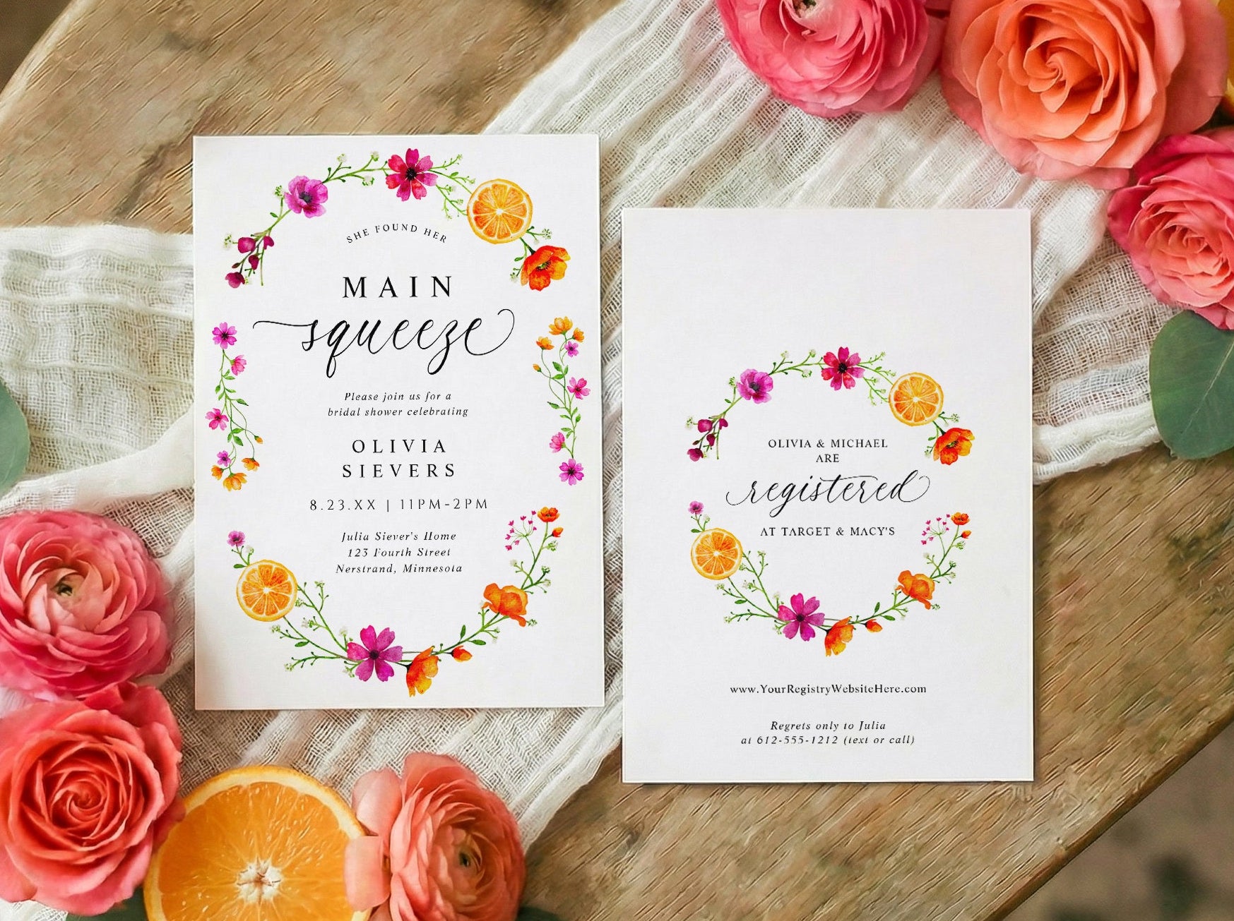 Bright citrus bridal shower invitations on a wooden surface with flowers and oranges.