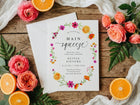 Main Squeeze bridal shower invitation with citrus and floral design surrounded by roses and oranges on a wooden surface