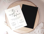 Wedding rehearsal dinner invitation card on a wooden surface with a black card beside it.