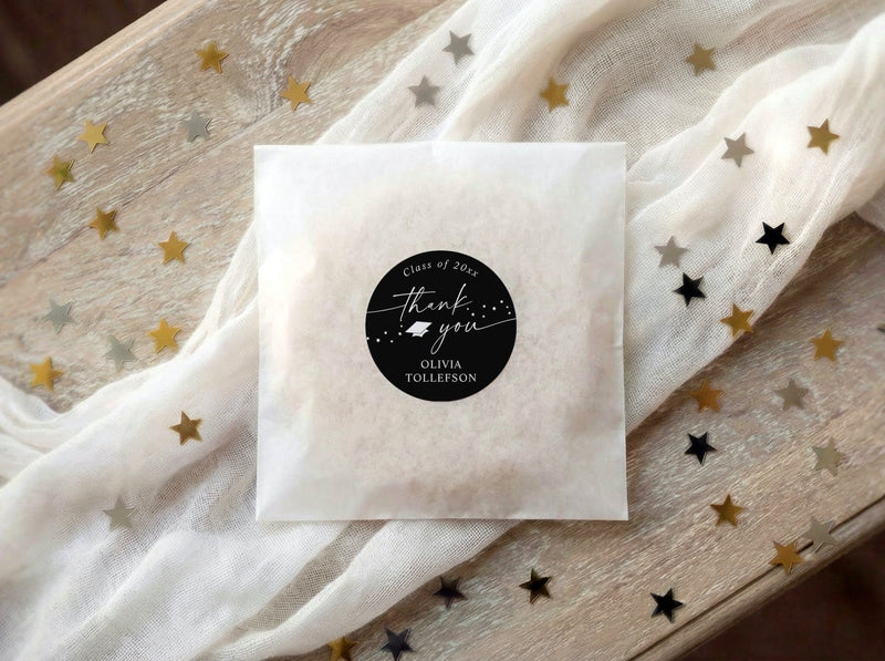 White graduation favor bag with personalized black and white thank you favor sticker.