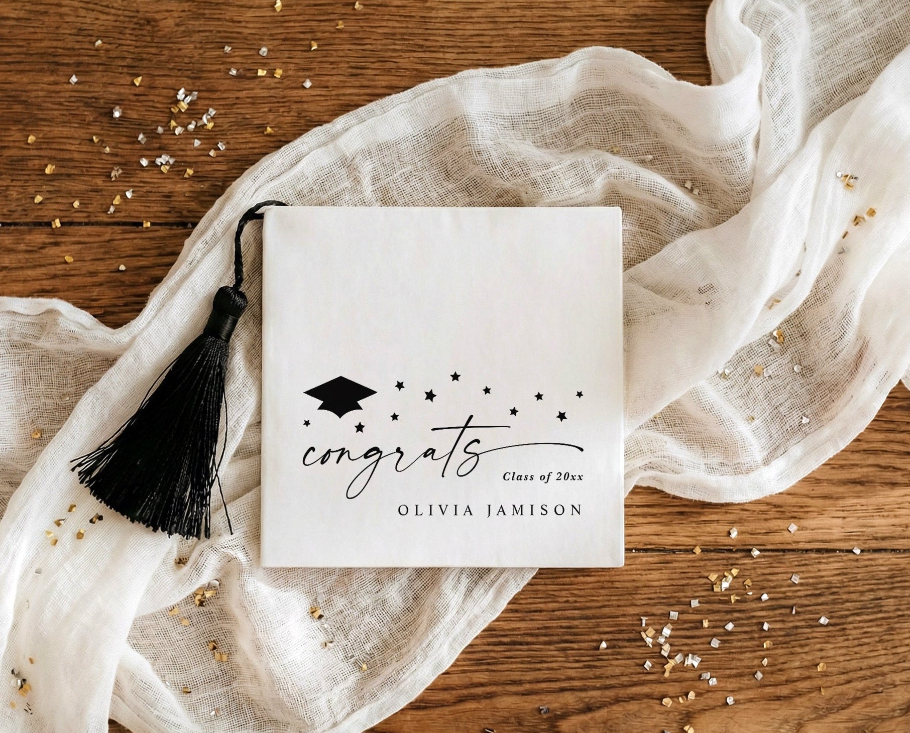 Black and white graduation napkins with script congrats, stars and graduation cap