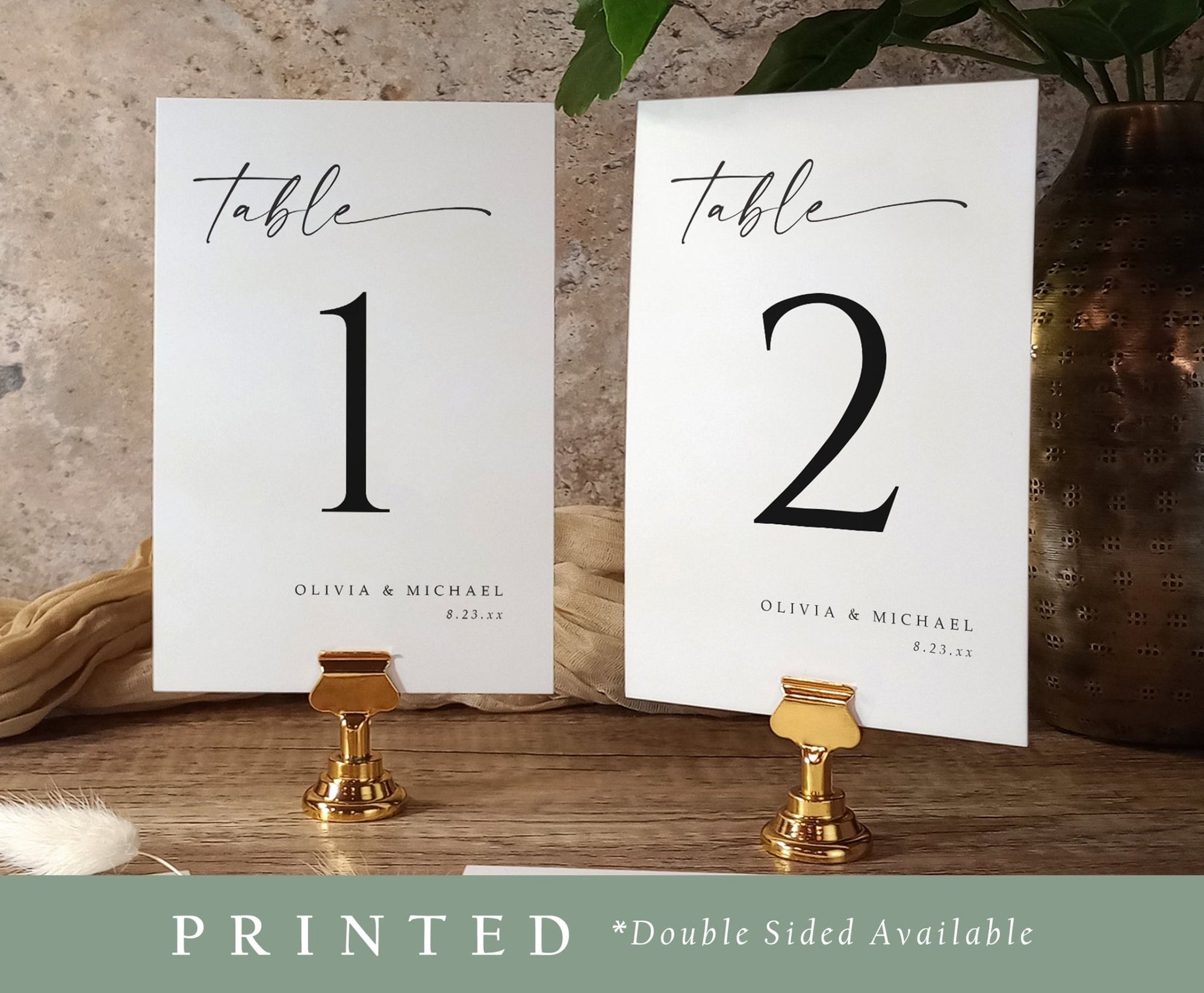 Elegant table number cards 1 and 2 for weddings, styled with gold stands and greenery
