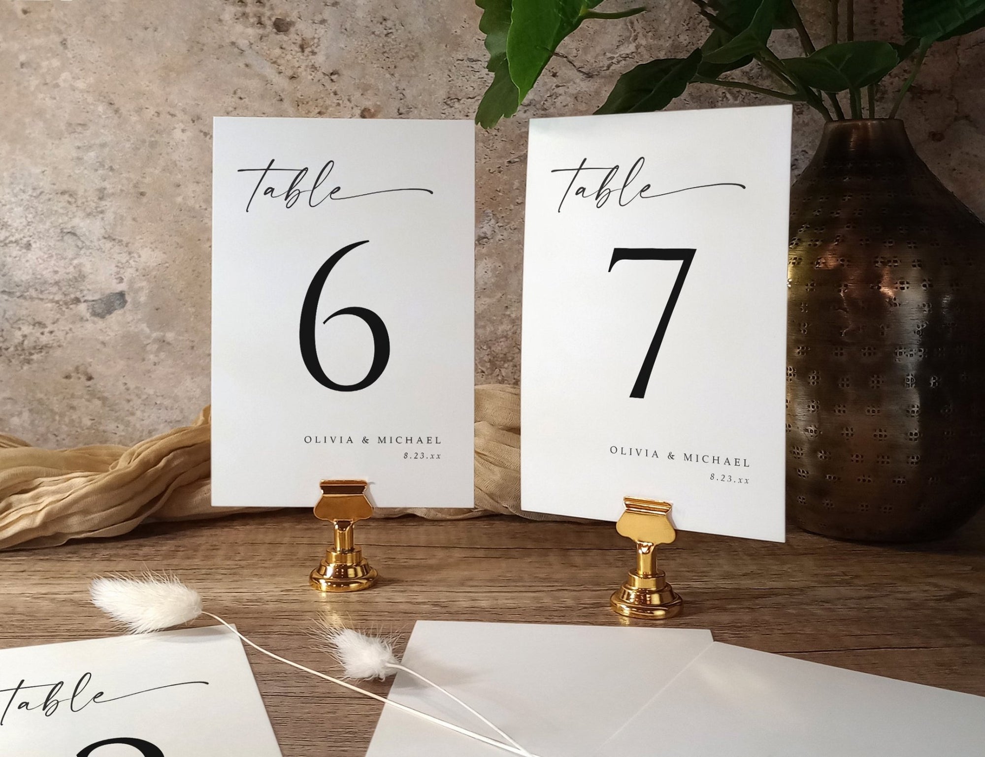 Custom printed table number cards for wedding in minimalist black and white design with handwritten script