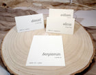 Place cards with names on a wooden surface