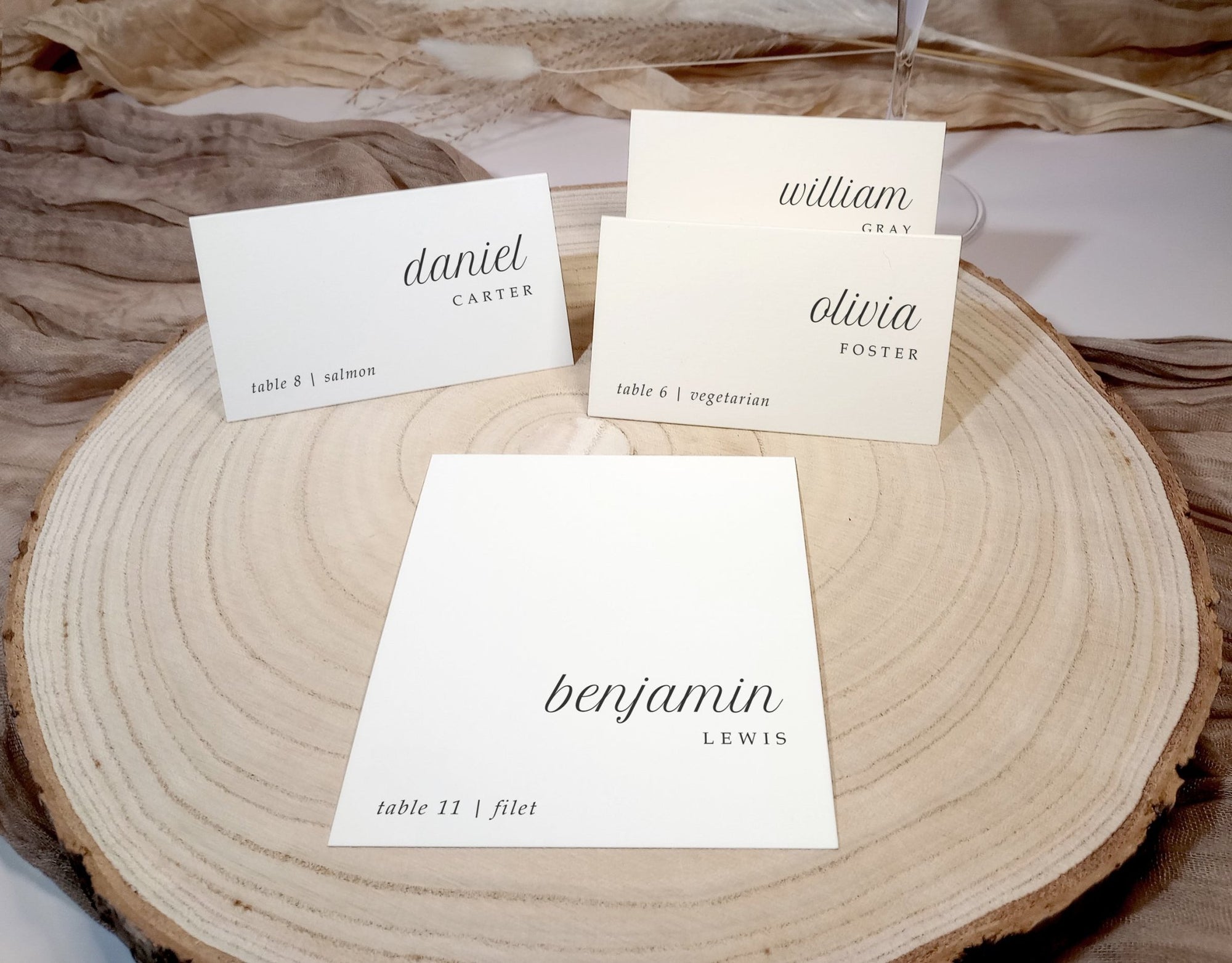 Place cards with names on a wooden surface