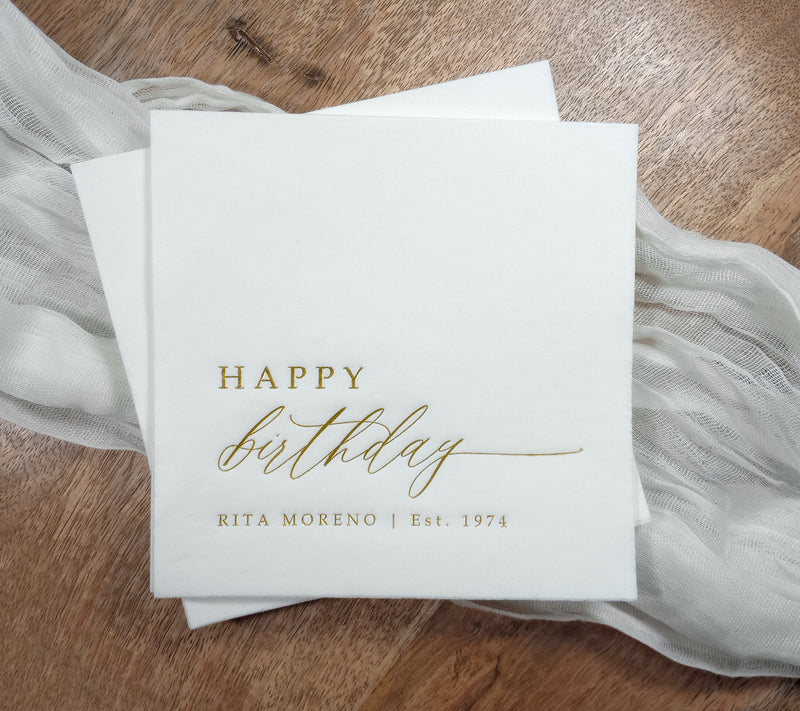 Elegant Birthday Party Napkins in cocktail size on a rustic table.