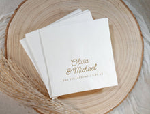 Personalized wedding napkin with whimsical script names in gold foil on wood plate