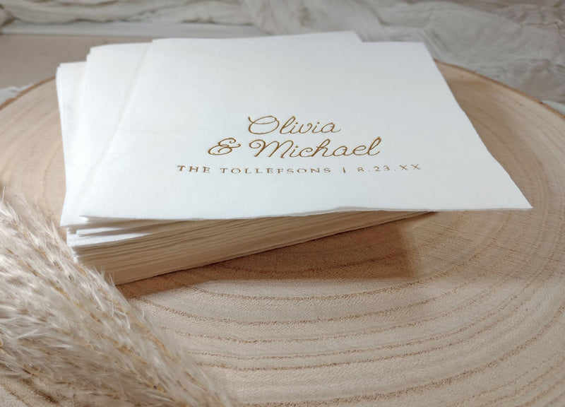 Custom whimsical script foil wedding napkins stacked on plate
