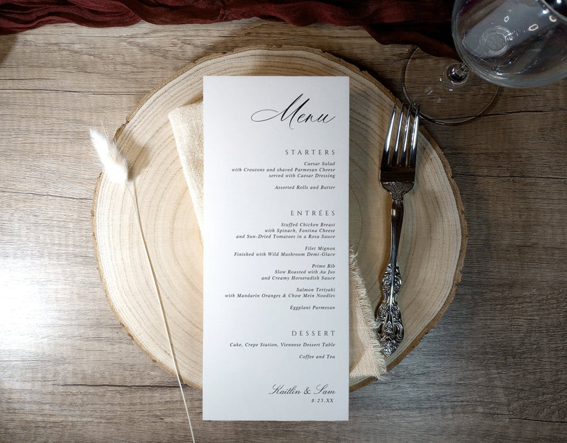 Custom printed wedding menu card with elegant script, displayed on wood charger at reception place setting
