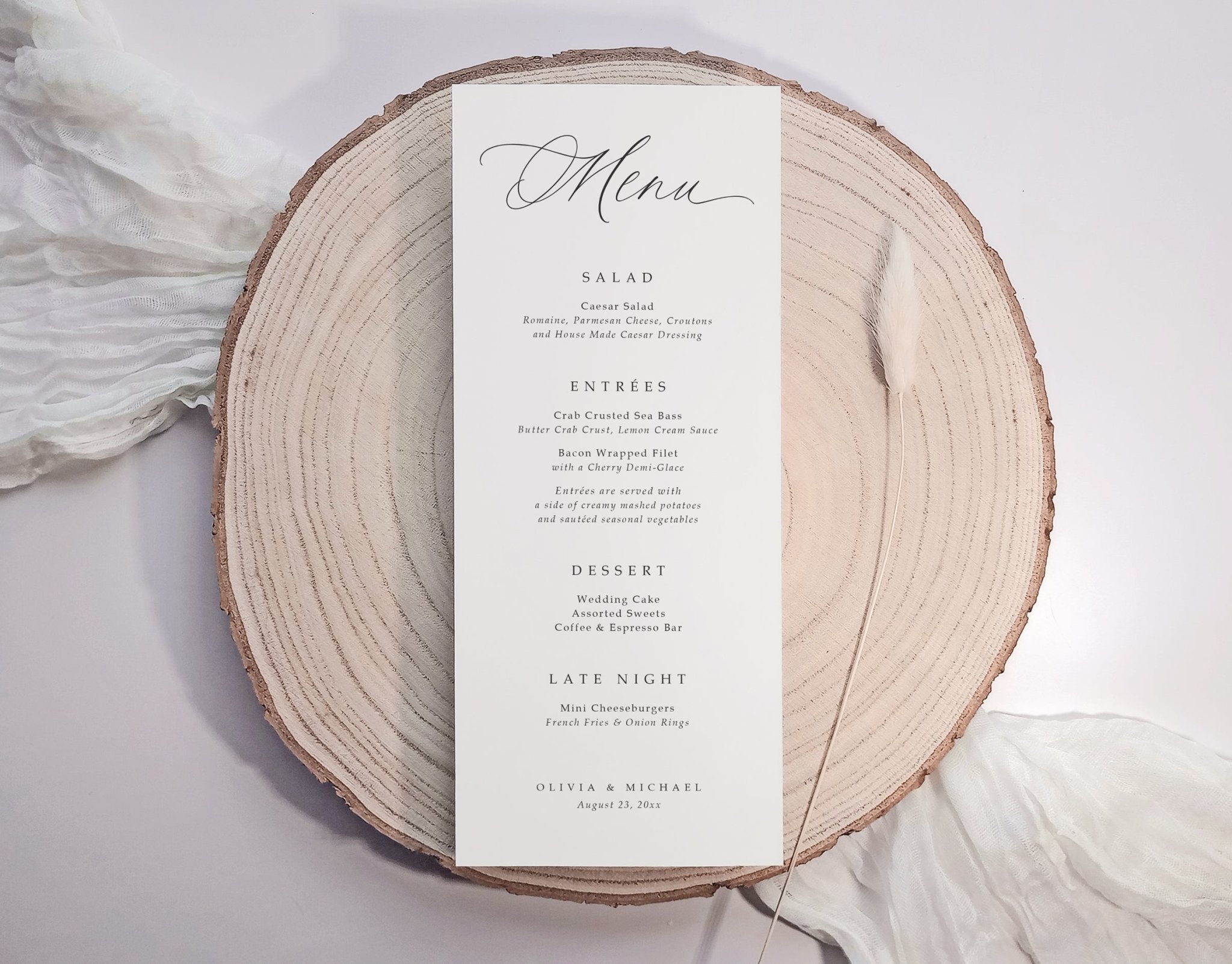 Custom printed modern wedding menu card on white cardstock with black serif font, styled on linen napkin.