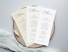 Set of menu cards on a wooden board with a light gray background