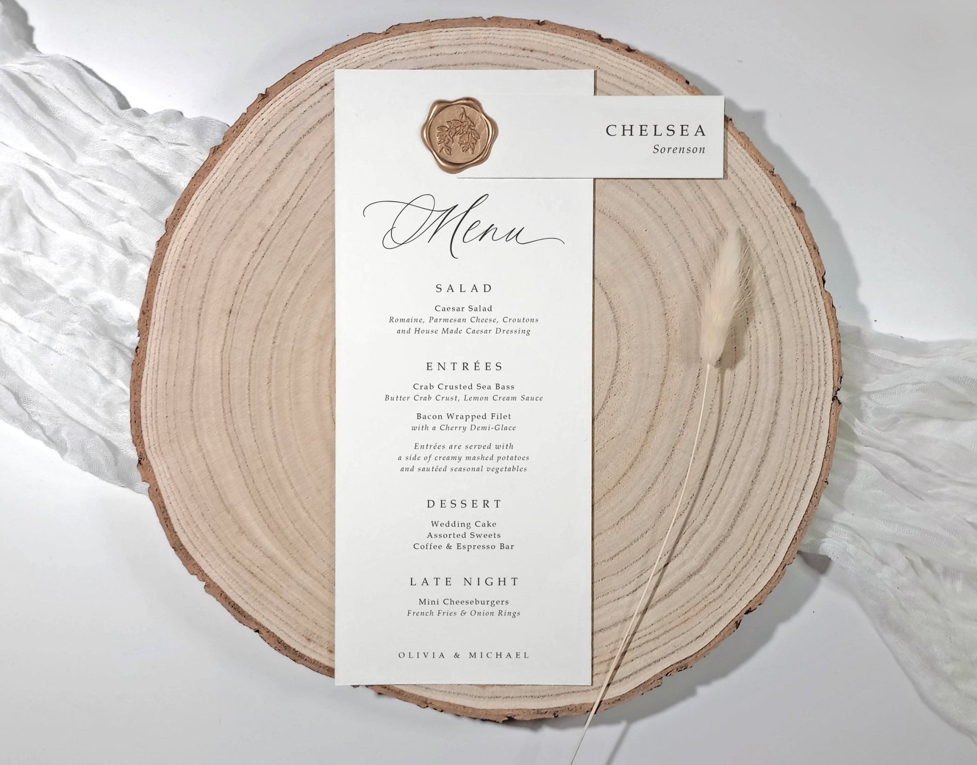 Menu card on a wooden slice with wax seal and name tag.