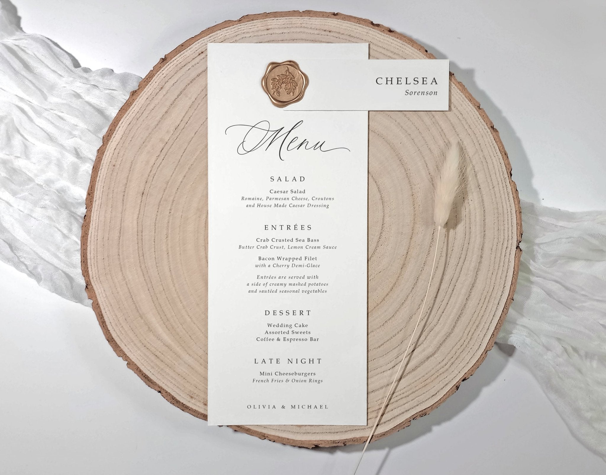 Menu card on a wooden slice with wax seal and name tag.