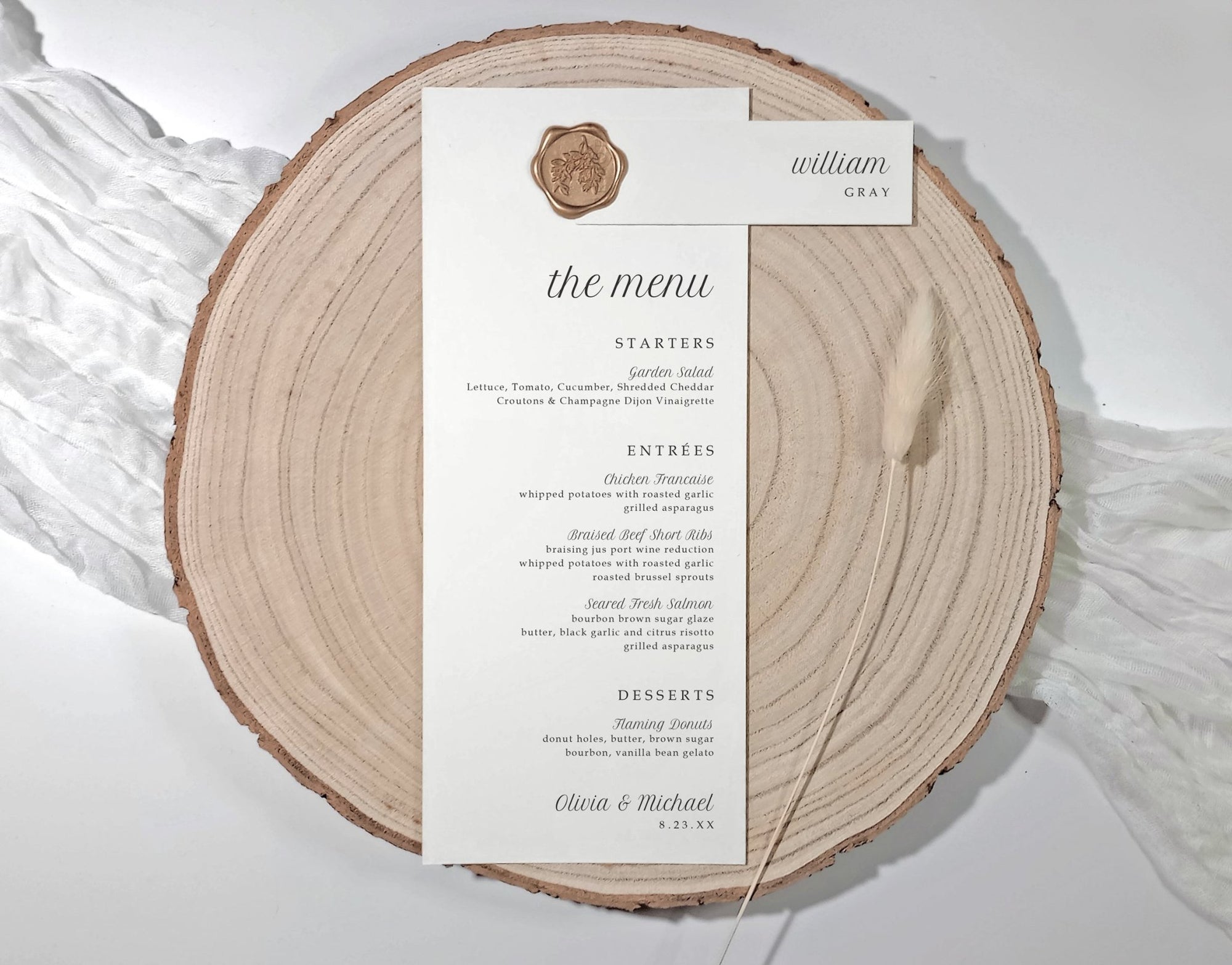 Menu card with attached name tag on a wooden slice with a white background
