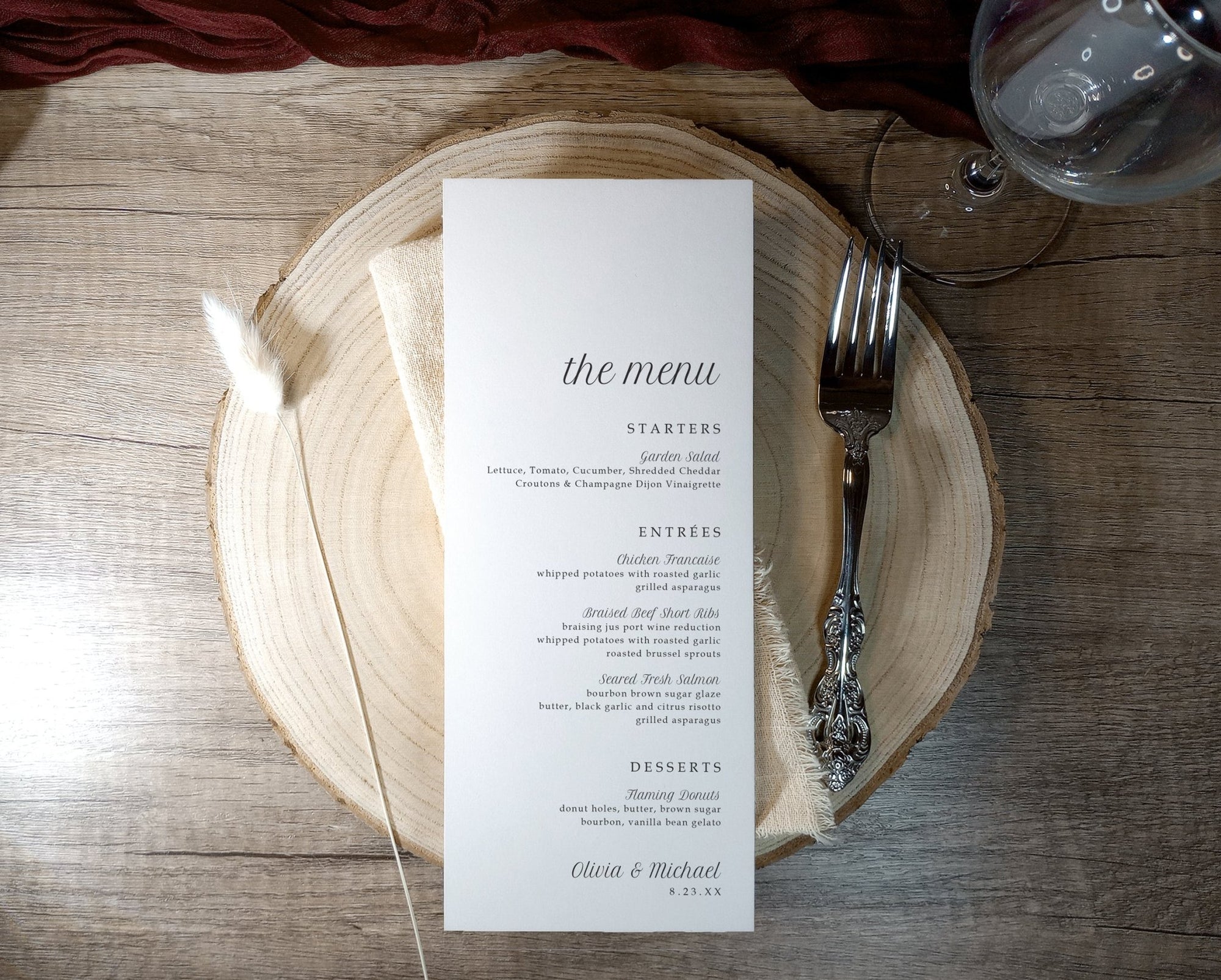 Menu card on a wooden plate with cutlery on a rustic wooden table