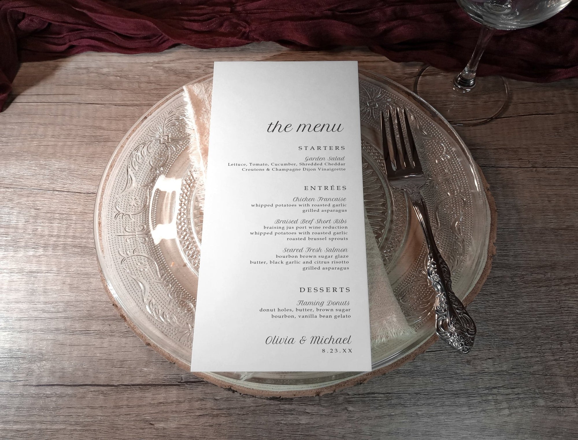 Menu card on a glass plate with silverware on a wooden table