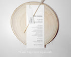 Wedding menu card with translucent name tag n a wooden round board with 'the menu' text.