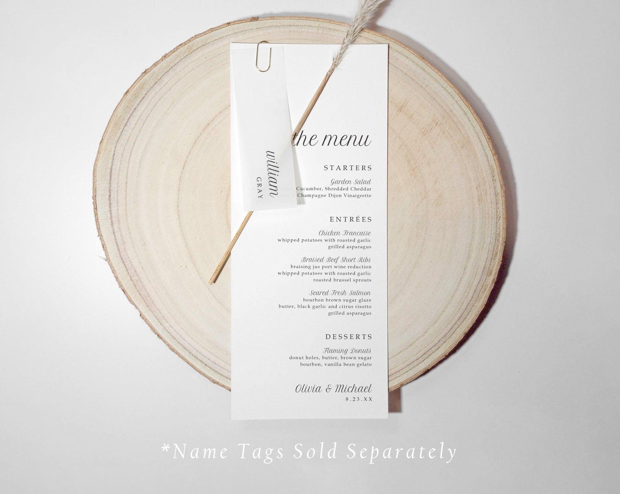 Wedding menu card with translucent name tag n a wooden round board with 'the menu' text.