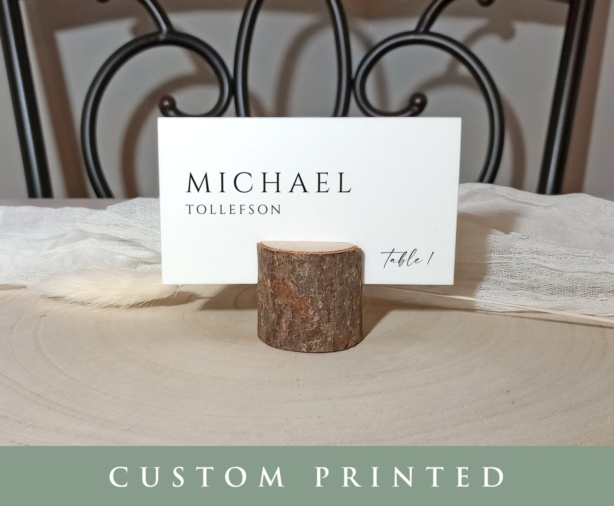 Custom printed wedding tent card displayed on linen napkin with wood slice holder