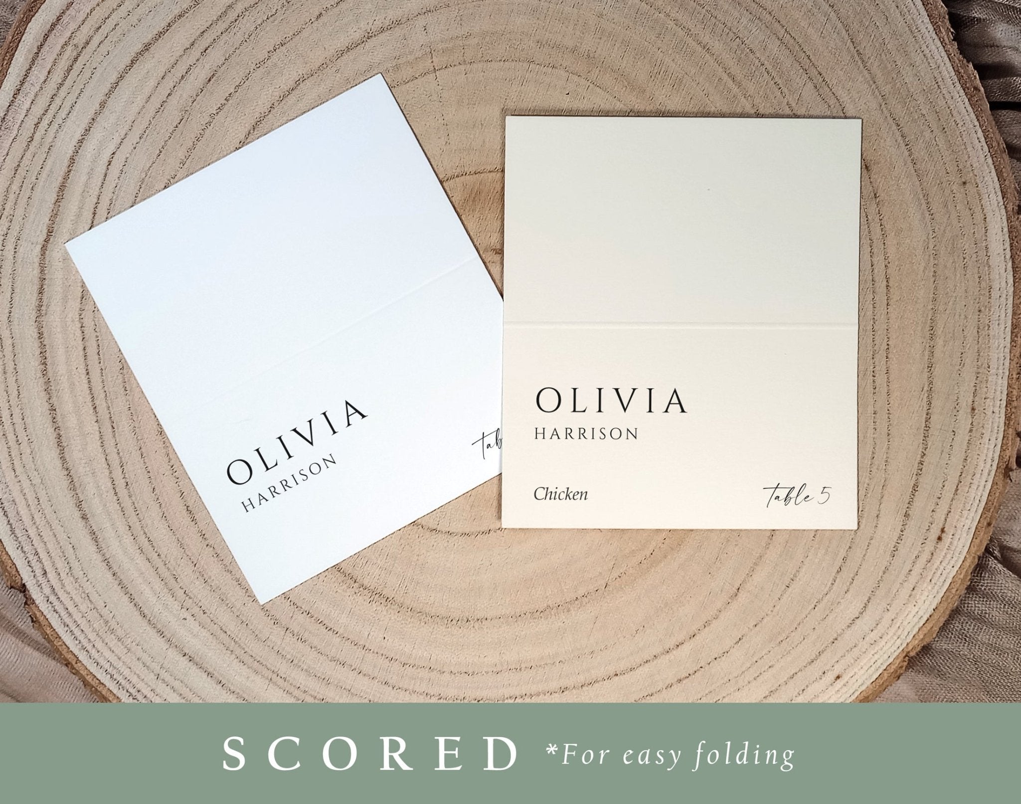Pre-scored wedding tent place cards in black and white, styled on wood with simple background