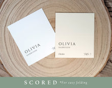 Pre-scored wedding tent place cards in black and white, styled on wood with simple background
