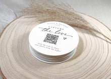 Stack of modern script QR code wedding coasters for guests to scan and upload photos