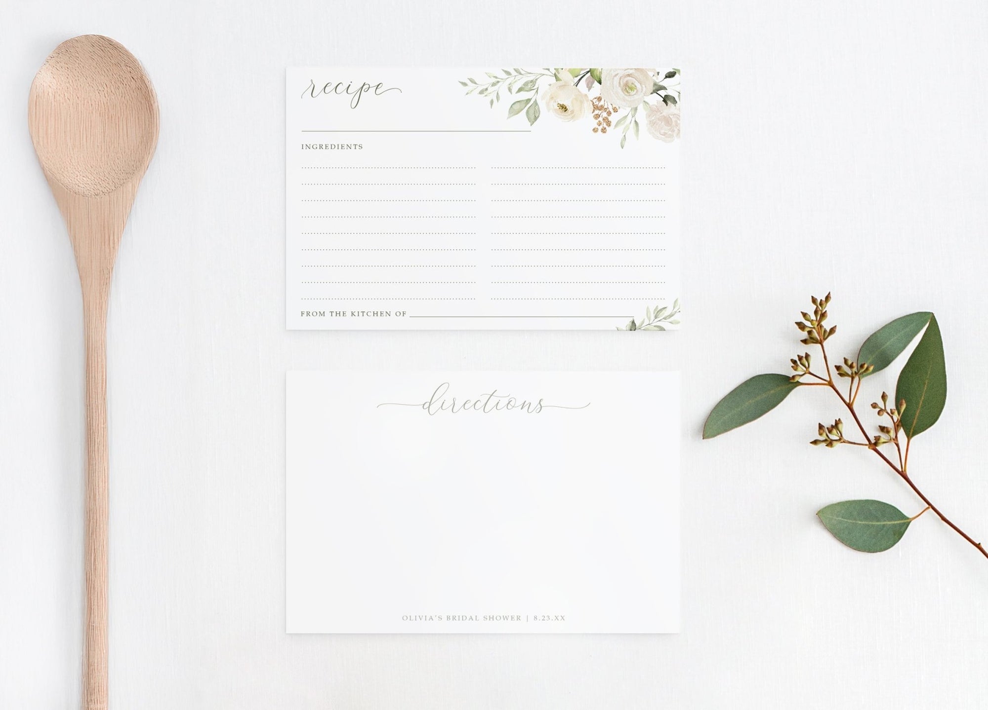 Recipe card with floral design, wooden spoon, and eucalyptus leaves on a white background