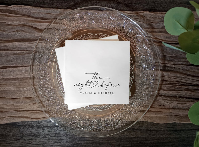 Black and white rehearsal dinner napkins with “the night before” modern script and heart.