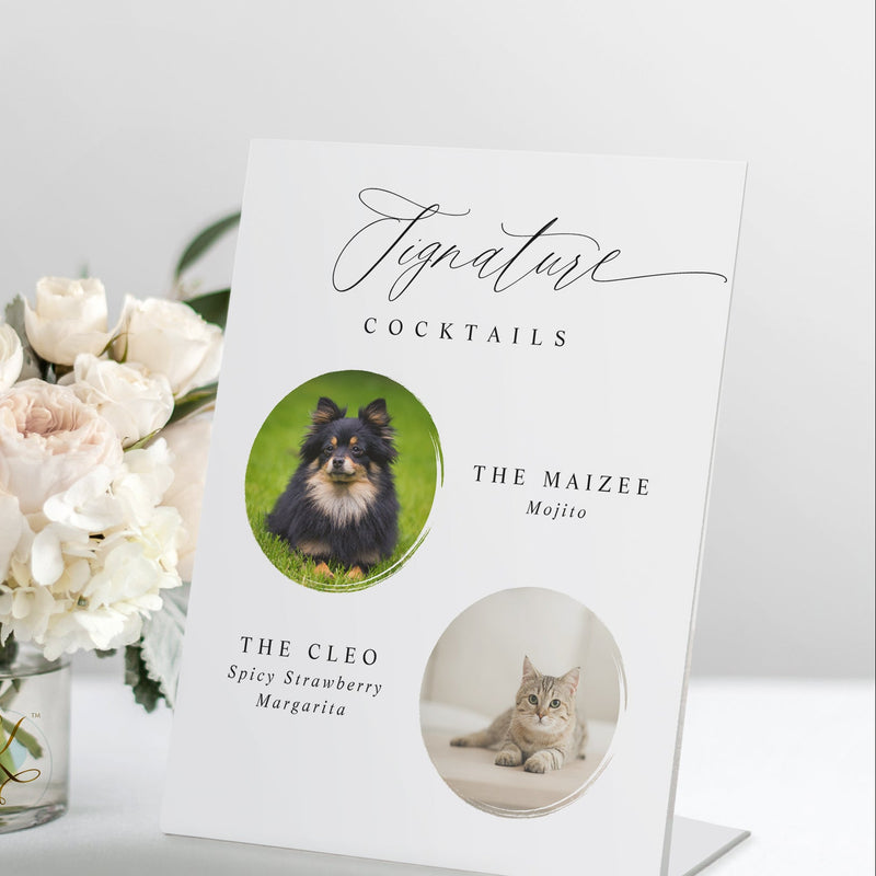 Signature Drinks Sign with 2 pets - by a white and blush floral arrangement on a wedding reception table.
