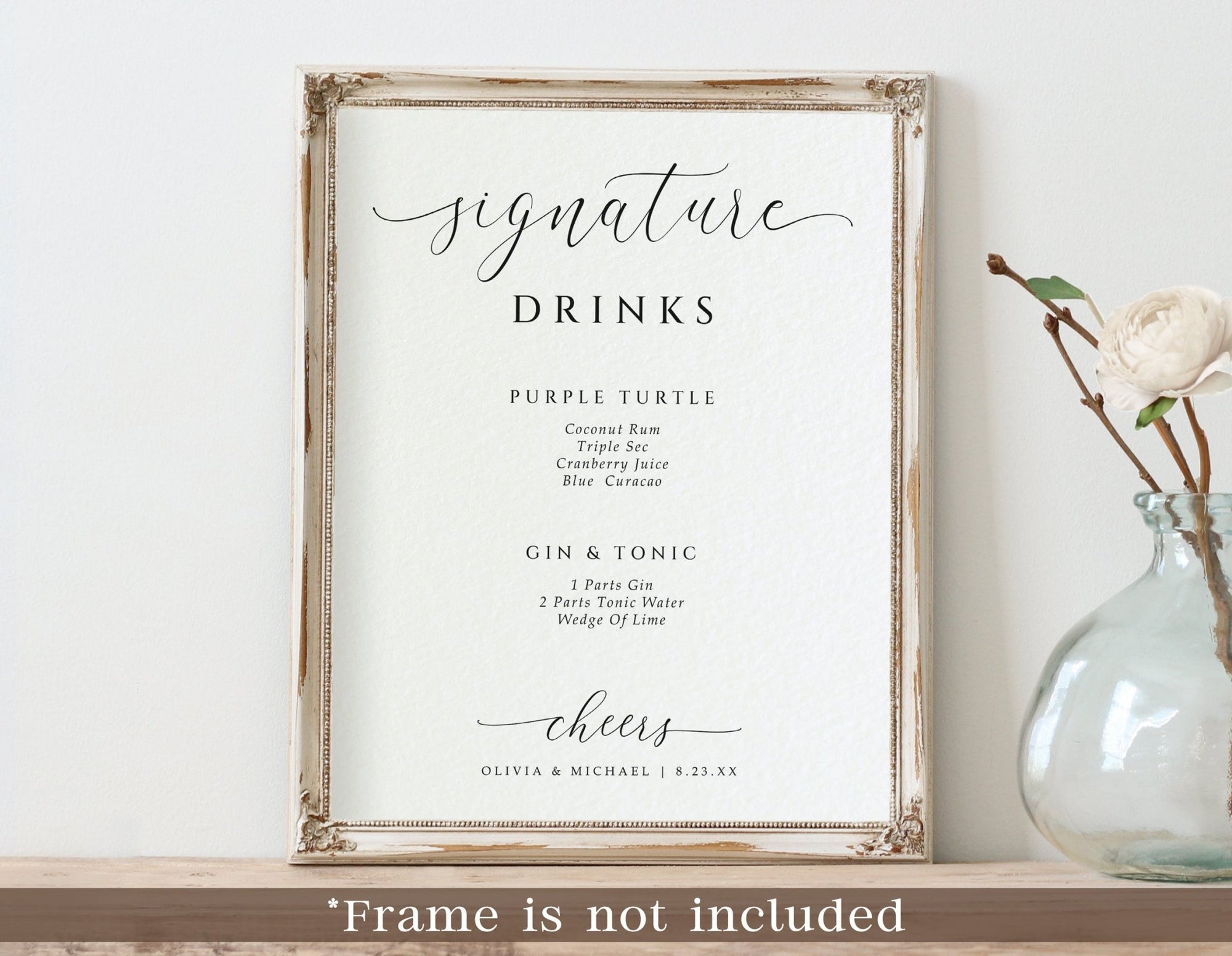 framed wedding bar sign reading “Signature Drinks” with two custom cocktails listed