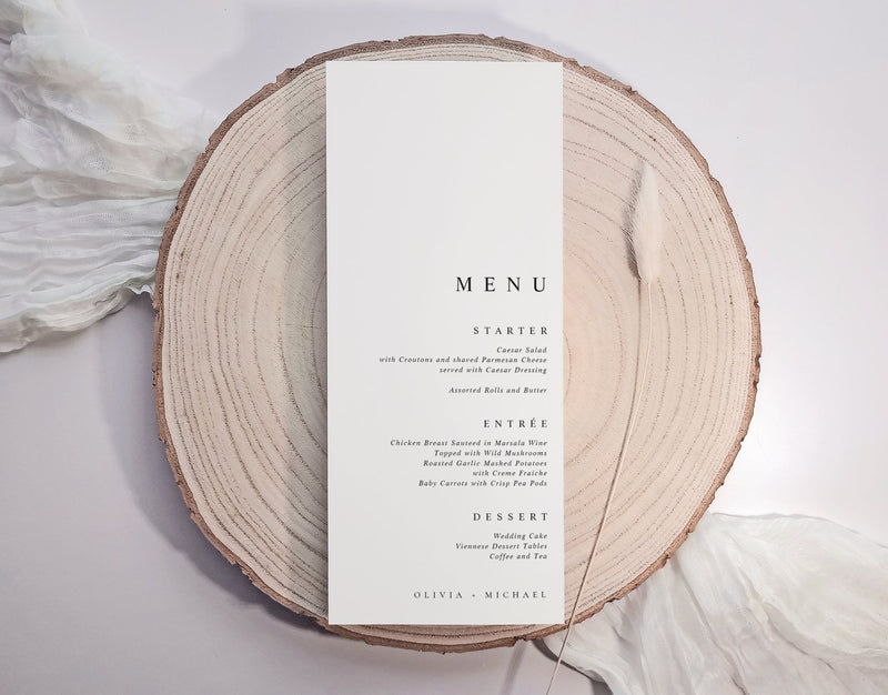 Simple elegant menu card on a wooden slice with a white background