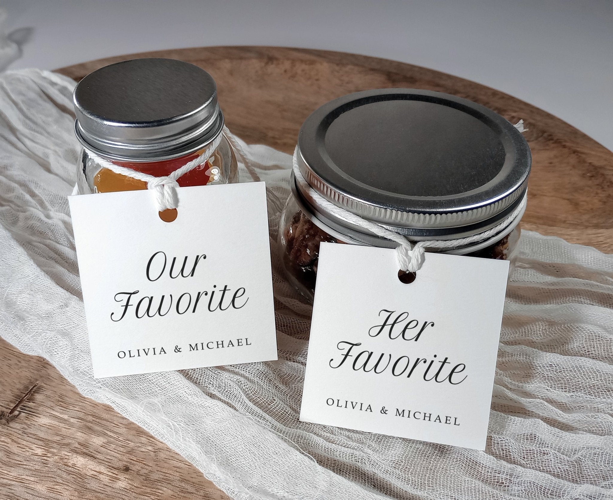 minimalist favor tags reading “Our Favorite” and “Her Favorite” tied to glass jars
