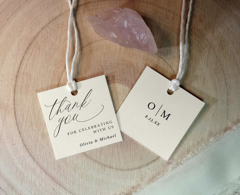 front and back of wedding favor tag shown with romantic calligraphy and couple’s initials