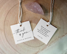 square thank you favor tags with names and date shown with string on wood and rose quartz