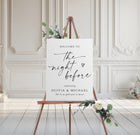 Rehearsal Dinner welcome sign on an easel with floral decorations in a elegant room.