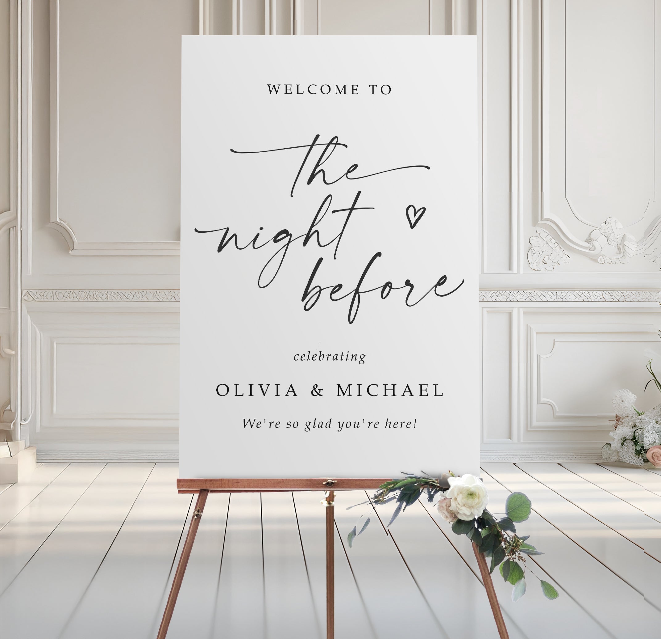 Rehearsal welcome sign on an easel with floral decorations in a elegant room.