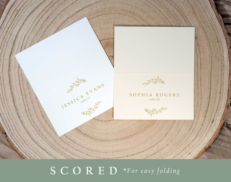 Custom printed gold place card for formal wedding, featuring classic laurel crest and guest names