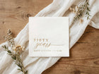 Gold foil 50th anniversary cocktail napkins with elegant script reading fifty years